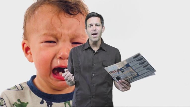 A crying toddler in the foreground with a confused man holding tickets standing behind him