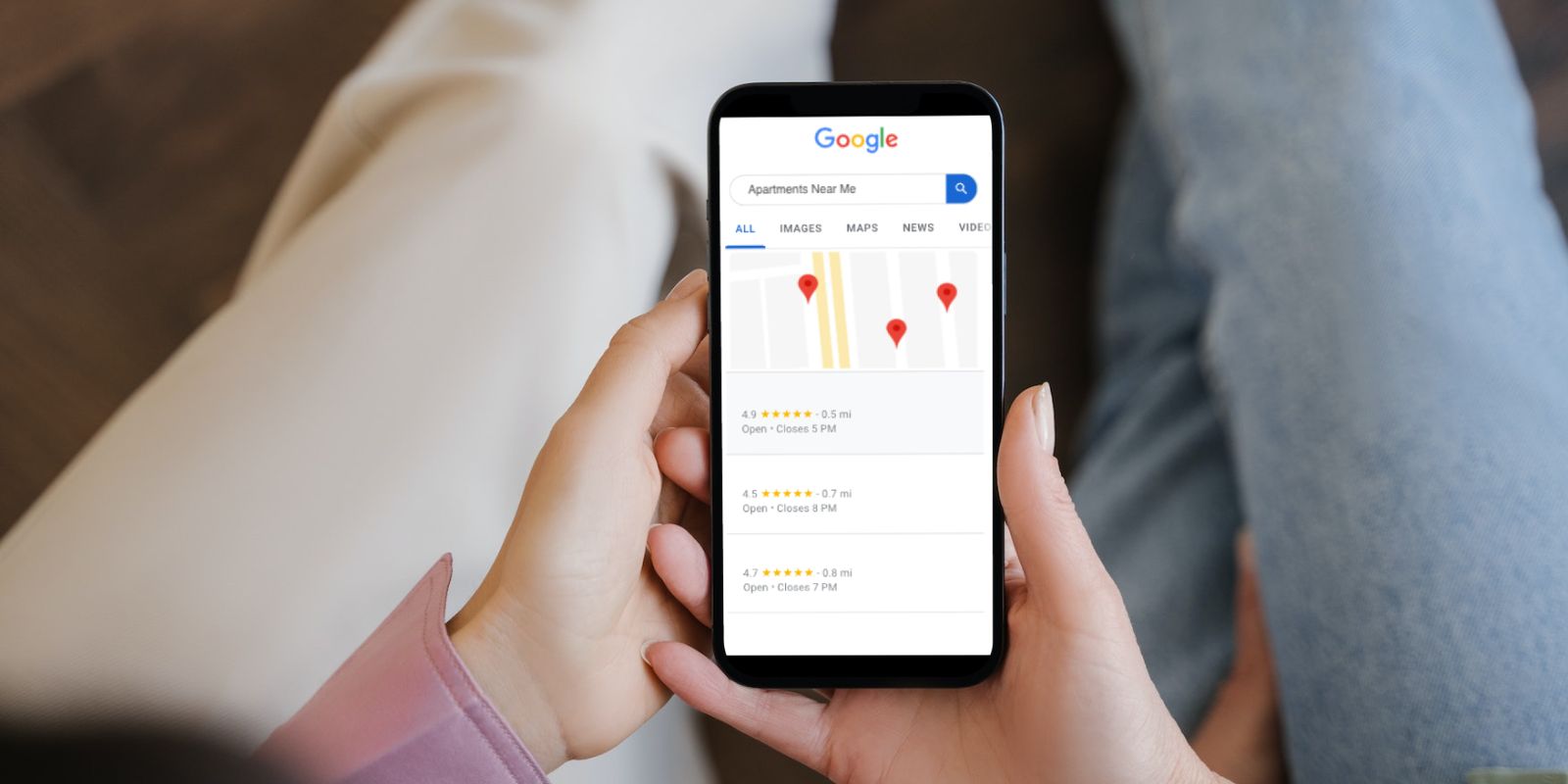 holding phone with maps open
